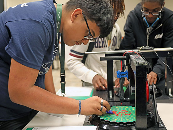This is a photo of a student at an interactive display at last year's afterschool expo